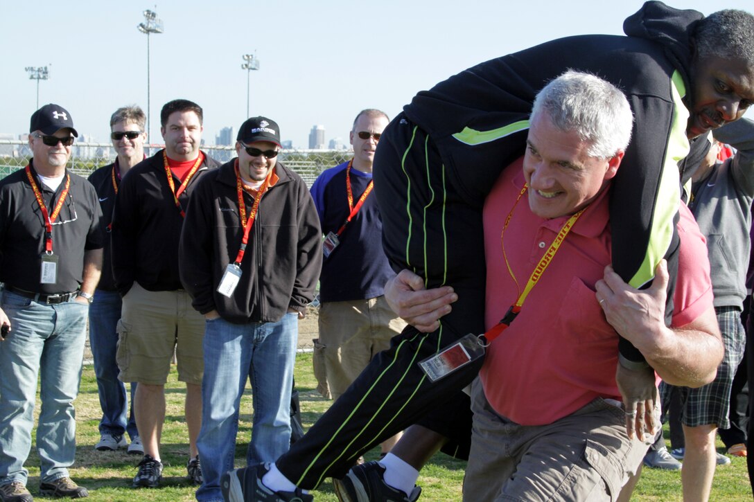 Lonnie Hoxie, vice principal, Jenkins High School, Chewelah, Wash., fireman carries Sam Jackson, vice principal, Inglemoor High School, Kenmore, Wash., during the maneuver under fire portion of the Combat Fitness Test during an educators workshop aboard Marine Corps Recruit Depot San Diego, Calif., Jan. 17. Several educators volunteered to participate in the ammo can lifts and maneuver under fire portions of the CFT.