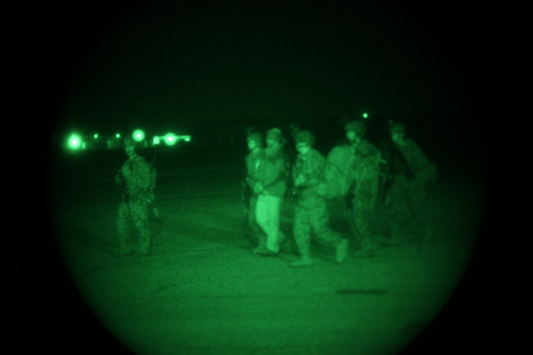 Marines escort a simulated detainee here who was captured during a mock raid conducted by the 24th Marine Expeditionary Unit’s Force Reconnaissance Platoon and the Security Element Platoon, Battalion Landing Team 1st Battalion, 2nd Marine Regiment, 24th MEU, at a Virginia Beach police training facility in Creeds Jan.17, 2012. The raid was part of the 24th MEU’s Realistic Urban Training (RUT) exercise scheduled Jan. 5-20, which focuses on conducting off-base missions near the towns of Farmville and Creeds to prepare for the various operations they may conduct while deployed.