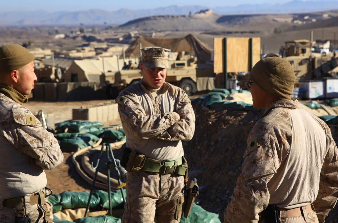 Chief Warrant Officer 3 Robert Lee (left), the bulk fuel officer with Bulk Fuel Platoon, 9th Engineer Support Battalion, 2nd Marine Logistics Group (Forward), discusses operations with Staff Sgt. Joseph Siggins (center), the operations chief with the unit, and Sgt. Xuchill Laput, a regional site manager for four fuel farms belonging to 9th ESB, aboard Forward Operating Base Whitehouse, Afghanistan, Jan. 18. During Lee and Siggins’ visit, Laput demonstrated how he and his Marines maintain an efficient, regulated fuel farm. (U.S. Marine Corps photo by Cpl. Katherine M. Solano)