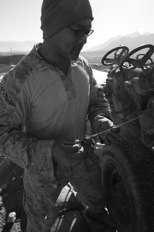 Sgt. Xuchill Laput, a regional fuel farm site manager with Bulk Fuel Platoon, 9th Engineer Support Battalion, 2nd Marine Logistics Group (Forward), checks the oil level in a pump aboard Forward Operating Base Whitehouse, Afghanistan, Jan. 18. Laput maintains strict environmental and military specification standards at all four of his fuel farm sites around the province. (U.S. Marine Corps photo by Cpl. Katherine M. Solano)