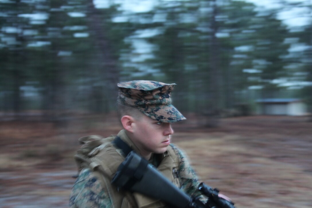 Sgt. Jacob R. Ruggles, an assistant data clerk with Marine Air Control Squadron 2, moves to contact during the second day of a field exercise MACS-2 conducted at Combat Town aboard MCB Camp Lejeune, N.C., Jan. 18. Combat Town is a training facility used to increase proficiency while partrolling through urban environments.