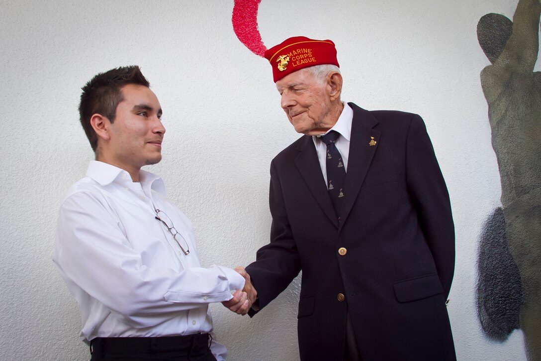 James C. Phillips, an Iwo Jima veteran, is honored by cadets and students at G. Holmes Braddock Senior High School in Miami, Fla., Jan. 18, 2012. The school’s Junior Naval Reserve Officer Training Corps painted a mural of the iconic flag raising on Mount Suribachi as a testament to Phillips and all veterans.    “Jack,” as his friends call him – his father’s name – was recognized for his service as a machine gunner with the 5th Marine Division on Iwo Jima.