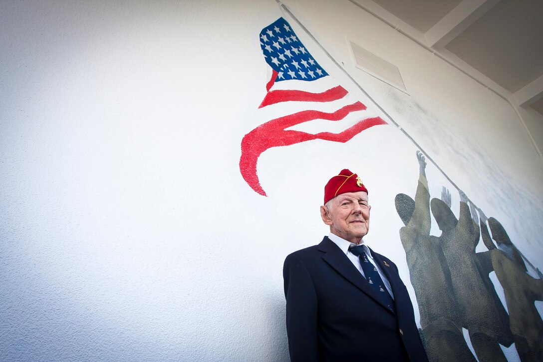 James C. Phillips, an Iwo Jima veteran, is honored by cadets and students at G. Holmes Braddock Senior High School in Miami, Fla., Jan. 18, 2012. “Jack,” as his friends call him – his father’s name – was recognized for his service in World War II as a machine gunner with the 5th Marine Division on Iwo Jima.    The school’s Junior Naval Reserve Officer Training Corps painted a mural of the iconic flag raising on Mount Suribachi as a testament to Phillips and all veterans.