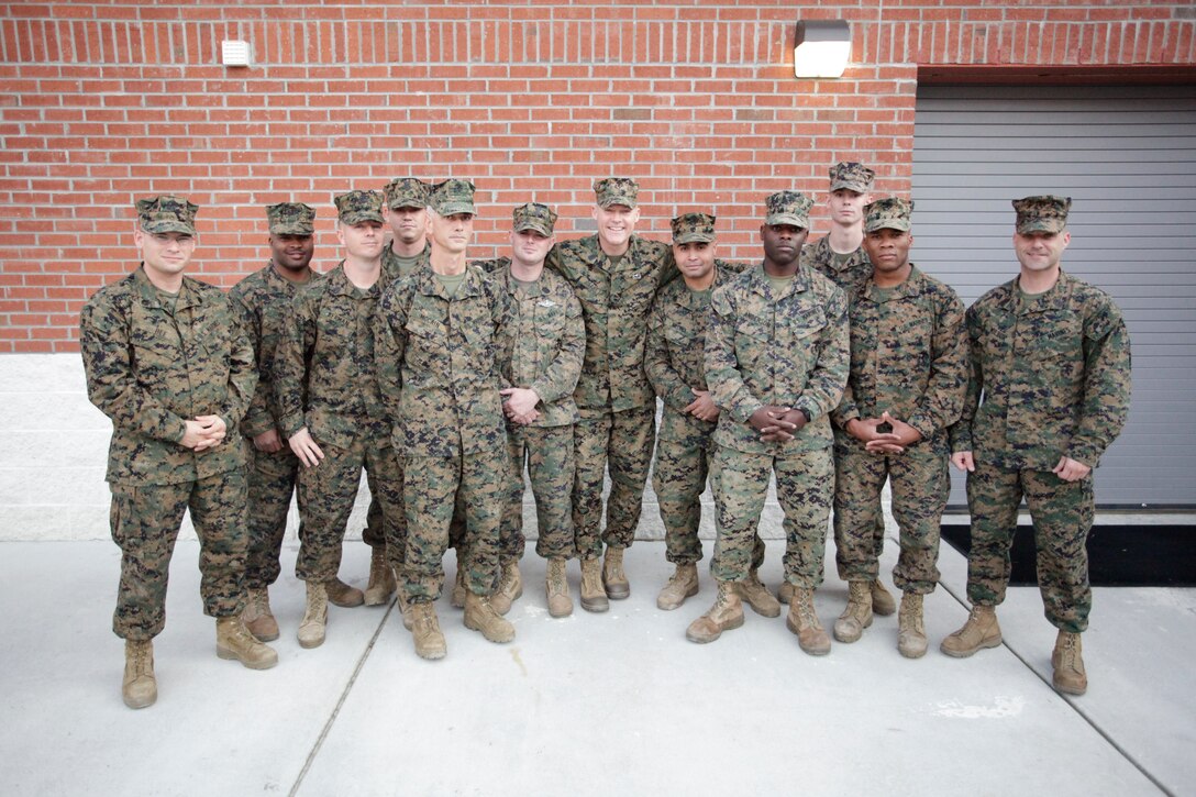Cpl. Gregory S. Pugh, left, receives a challenge coin from Lt. Gen. Kenneth J. Glueck Jr. during a brief at the Camp Foster Theater Jan. 18. Glueck addressed the Marines regarding Combat Logistics Battalion 4’s upcoming deployment to Afghanistan in support of Operation Enduring Freedom. Brig. Gen. Craig C. Crenshaw also spoke to the Marines during the brief. Glueck is the commanding general of III Marine Expeditionary Force. Crenshaw is the commanding general of 3rd Marine Logistics Group, III MEF.  Pugh is a heavy-equipment operator with Company B, CLB-4, Combat Logistics Regiment 3, 3rd MLG.
