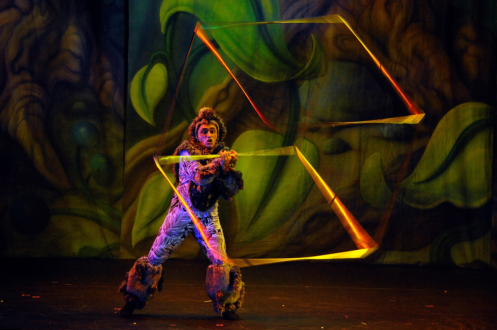 MISAWA CITY, Japan - A performer spins a metal frame box during the Cirque Dreams Jungle Fantasy World Tour show held at the Misawa Civic Center Jan. 18. Cirque Dreams Jungle Fantasy is an exotic encounter inspired by nature's unpredictable creations that are brought to life by an international cast of soaring aerialists, spine-bending contortionists, acrobats, jugglers and musicians. (U.S. Air Force photo/Tech. Sgt. Marie Brown)