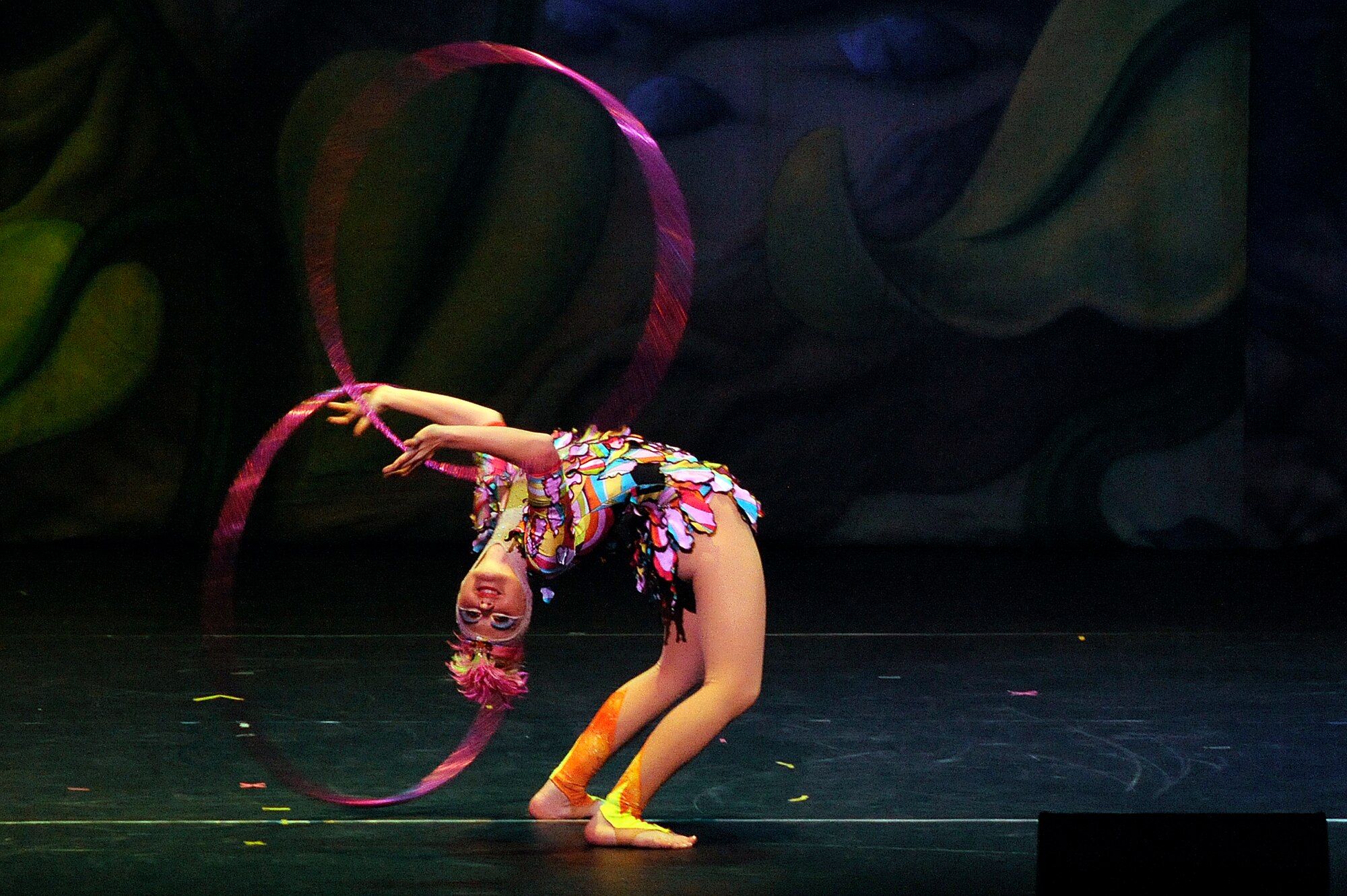 MISAWA CITY, Japan - A performer flexes backward while twirling hoops during the Cirque Dreams Jungle Fantasy World Tour show held at the Misawa Civic Center Jan. 18. Armed Forces Entertainment, a Defense Department agency, recruited Cirque Dreams to perform at military installations in Europe, the Pacific and Mediterranean. (U.S. Air Force photo/Tech. Sgt. Marie Brown)