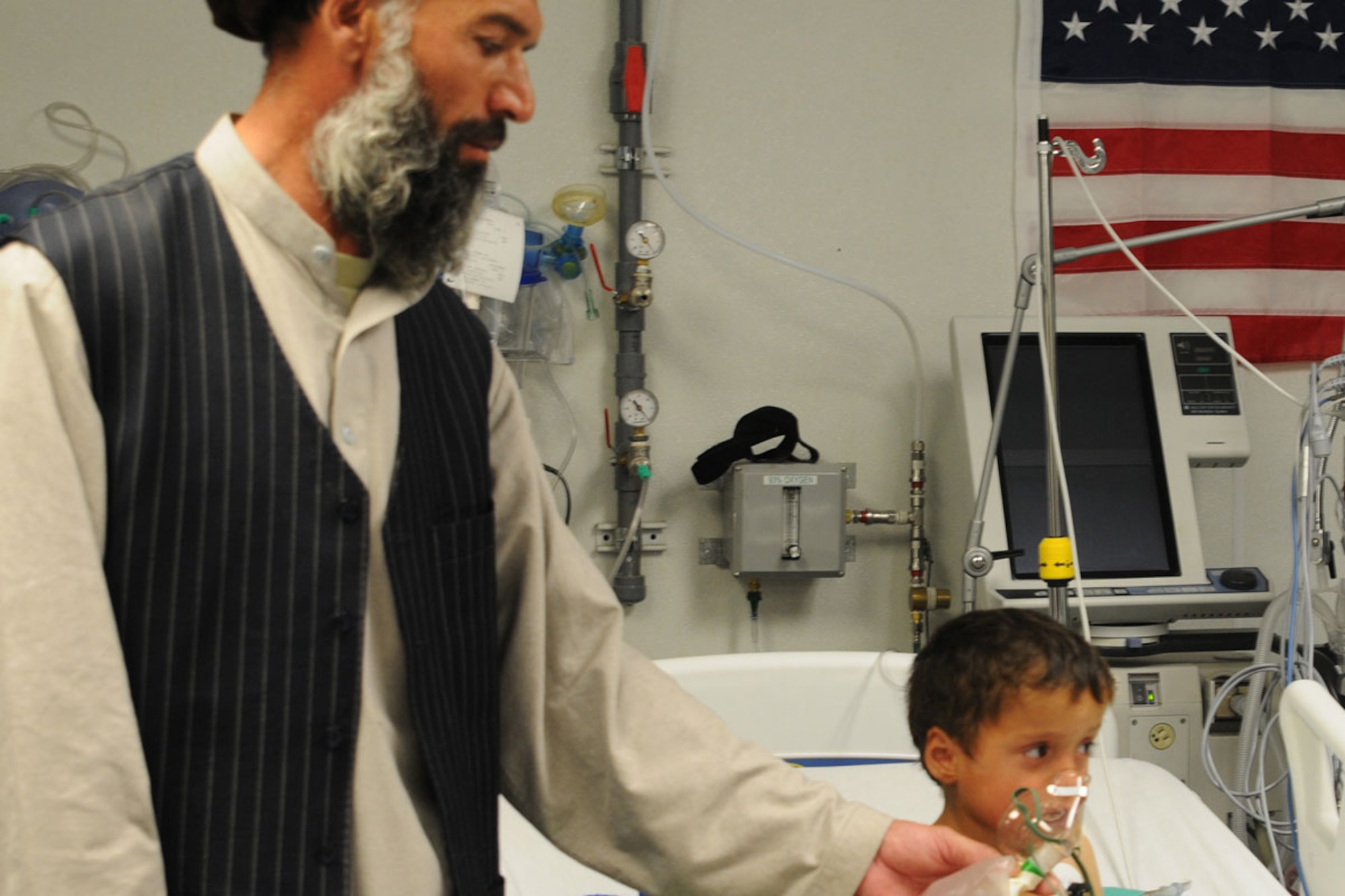 Farook, an Afghan child with his uncle, Shah Saied, being cared for after nearly dying from an asthma attack. He was medicaly evacuated to Salerno hospital to be treated. (U.S. Army photo/Spc. Eric-James Estrada, Task Force Spartan)