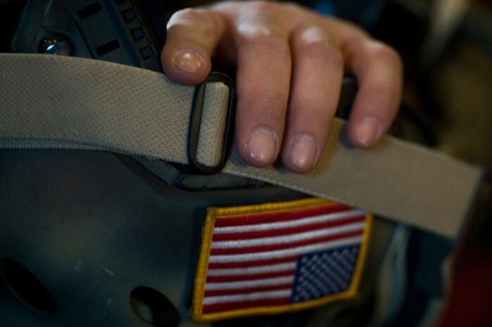 A U.S. Air Force pararescueman, 58th Rescue Squadron, holds his gear as he prepares to reach a designated drop zone during a military static-line jump mission Jan. 10, 2012, at Nellis Air Force Base, Nev. Pararescuemen are trained to provide emergency medical treatment in adverse terrain and conditions in combat or peacetime. (U.S. Air Force photo by Airman 1st Class Daniel Hughes/Released)

