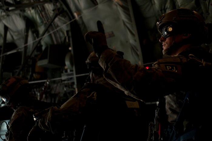 A U.S. Air Force pararescueman, 58th Rescue Squadron, prepares to jump out of a C-130 Hercules, Air National Guard, Long Island, NY, during a military static-line jump mission Jan. 13, 2012, at Nellis Air Force Base, Nev. Pararescuemen are trained to provide emergency medical treatment in adverse terrain and conditions in combat or peacetime. (U.S. Air Force photo by Staff Sgt. Christopher Hubenthal/Released)
