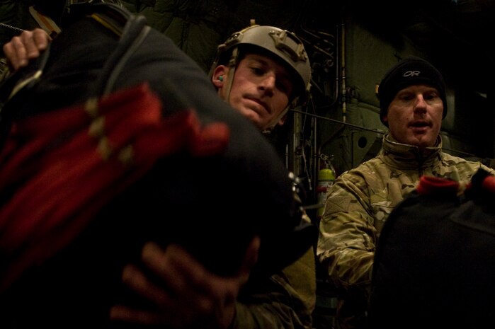 U.S. Air Force pararescuemen, 58th Rescue Squadron, arrange gear on a C-130 Hercules, Air National Guard, Long Island, NY, during a military freefall jump Jan. 11, 2012, at Nellis Air Force Base, Nev. Pararescuemen are trained to provide emergency medical treatment in adverse terrain and conditions in combat or peacetime. (U.S. Air Force photo by Airman 1st Class Daniel Hughes/Released)
