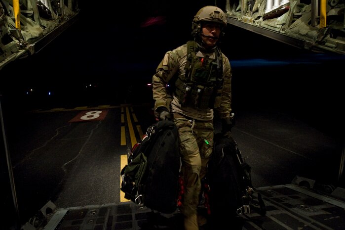 A U.S. Air Force pararescueman, 58th Rescue Squadron, boards a C-130 Hercules, Air National Guard, Long Island, NY, after completing a military freefall jump Jan. 11, 2012, at Nellis Air Force Base, Nev. Pararescuemen are trained to provide emergency medical treatment in adverse terrain and conditions in combat or peacetime. (U.S. Air Force photo by Airman 1st Class Daniel Hughes/Released)
