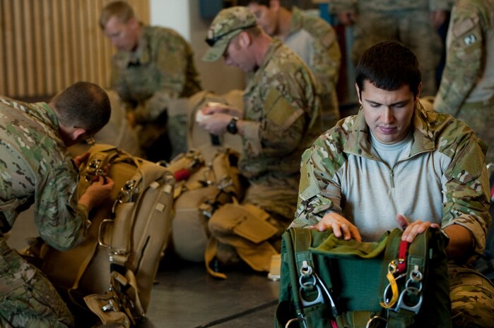 A U.S. Air Force pararescueman, 58th Rescue Squadron, prepares and checks equipment prior to a military freefall jump Jan. 11, 2012, at Nellis Air Force Base, Nev. Pararescuemen are trained to provide emergency medical treatment in adverse terrain and conditions in combat or peacetime. (U.S. Air Force photo by Staff Sgt. Christopher Hubenthal/Released)
                                                
