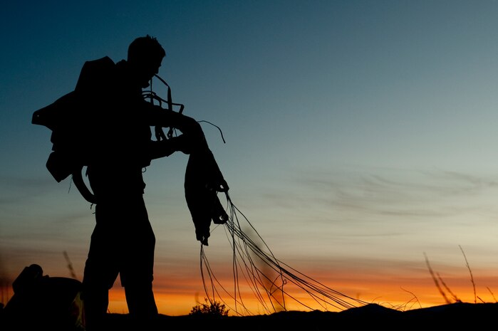 A U.S. Air Force pararescueman, 58th Rescue Squadron, gathers up his parachute after completing a military freefall jump Jan. 11, 2012, at Wendover Field, Utah. Pararescuemen are trained to provide emergency medical treatment in adverse terrain and conditions in combat or peacetime. (U.S. Air Force photo by Staff Sgt. Christopher Hubenthal/Released)
