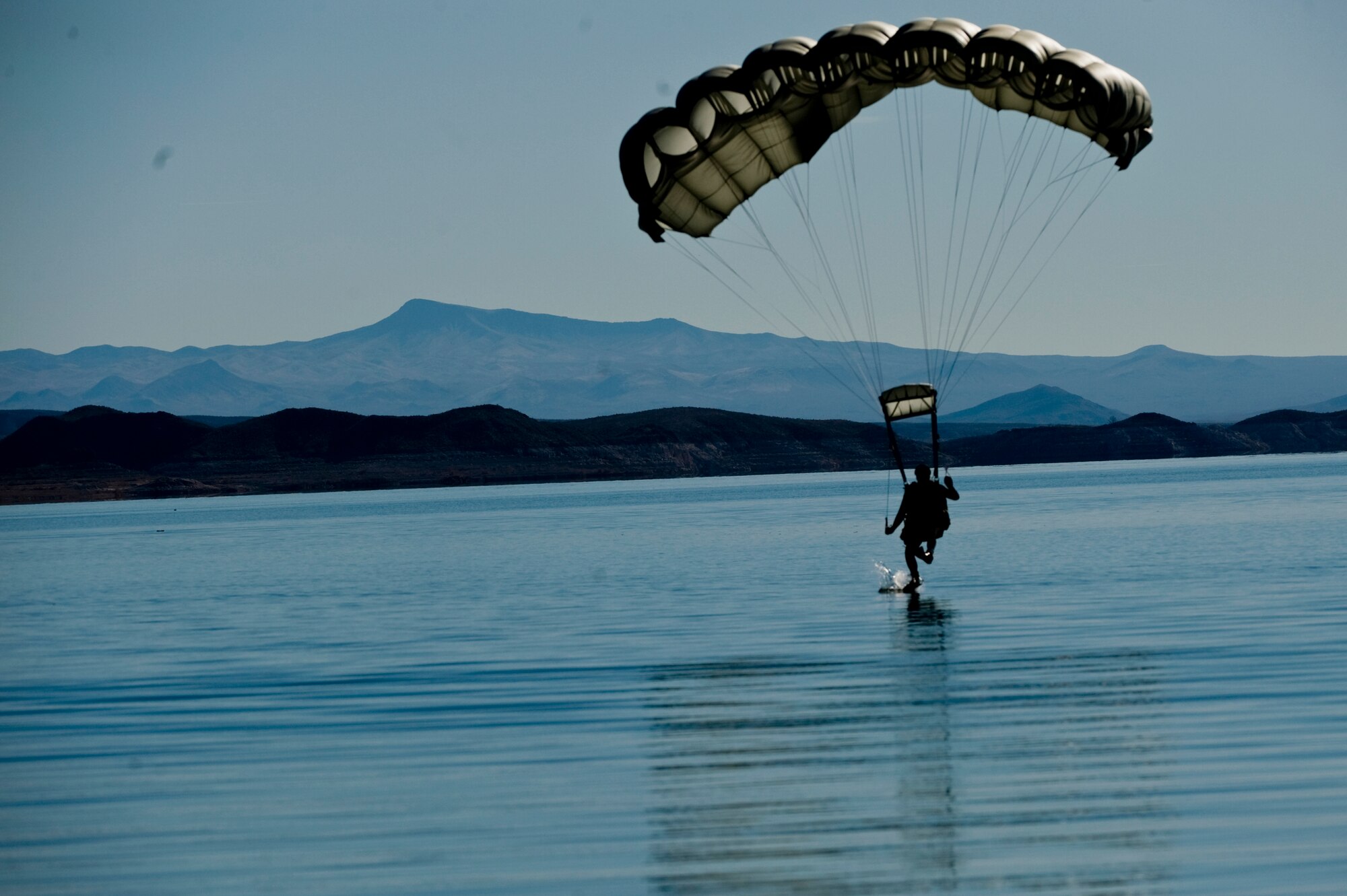 A U.S. Air Force pararescueman, 58th Rescue Squadron, prepares for a water landing during a military freefall water jump Jan. 10, 2012, over Echo Bay, Nev. Pararescuemen are trained to provide emergency medical treatment in adverse terrain and conditions in combat or peacetime. (U.S. Air Force photo by Staff Sgt. William Coleman/Released)
