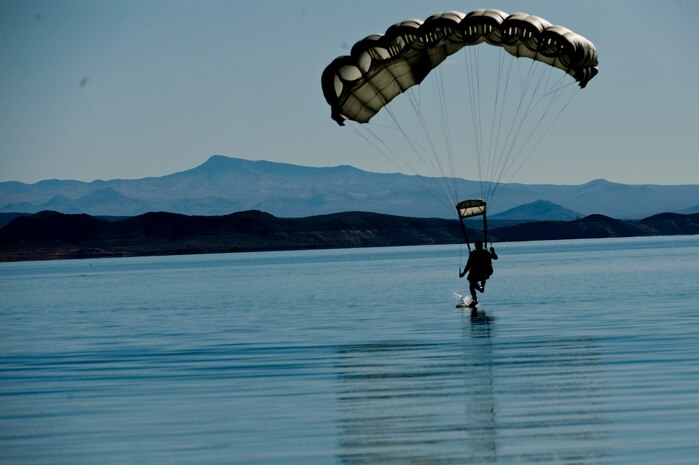 A U.S. Air Force pararescueman, 58th Rescue Squadron, prepares for a water landing during a military freefall water jump Jan. 10, 2012, over Echo Bay, Nev. Pararescuemen are trained to provide emergency medical treatment in adverse terrain and conditions in combat or peacetime. (U.S. Air Force photo by Staff Sgt. William Coleman/Released)
