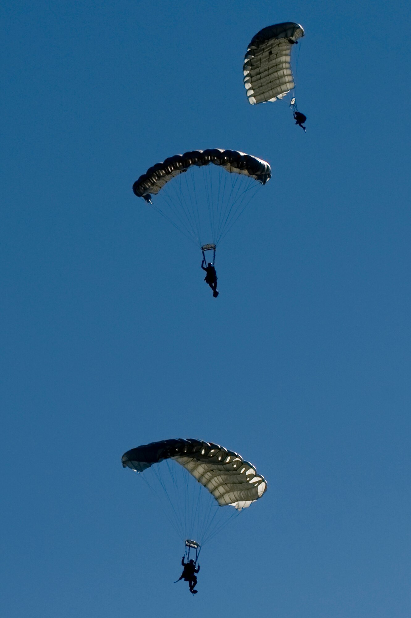 U.S. Air Force pararescuemen, 58th Rescue Squadron, prepare for a water landing during a military freefall water jump Jan. 10, 2012, over Echo Bay, Nev. Pararescuemen are trained to provide emergency medical treatment in adverse terrain and conditions in combat or peacetime. (U.S. Air Force photo by Staff Sgt. William Coleman/Released)

