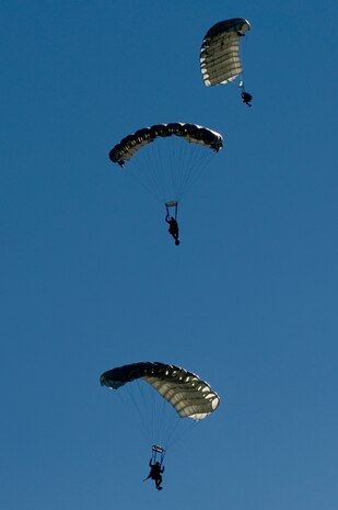 U.S. Air Force pararescuemen, 58th Rescue Squadron, prepare for a water landing during a military freefall water jump Jan. 10, 2012, over Echo Bay, Nev. Pararescuemen are trained to provide emergency medical treatment in adverse terrain and conditions in combat or peacetime. (U.S. Air Force photo by Staff Sgt. William Coleman/Released)

