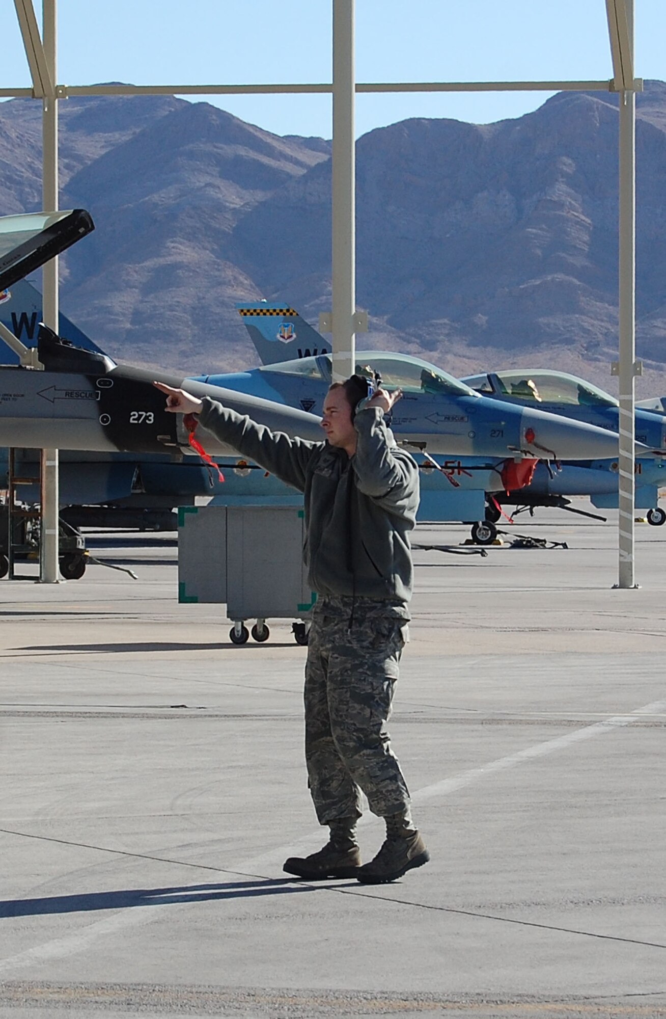 NELLIS AIR FORCE BASE, Nev. -- Staff Sergeant Andrew Sperry, 926th Aircraft Maintenance Squadron, taxis out an F-16 Aggressor aircraft here Jan. 7. The all-Reserve maintenance launch supported pilots headed to Tyndall Air Force Base, Fla., to augment the 43rd Fighter Squadron's air combat training there. (U.S. Air Force photo/Capt. Jessica Martin)
