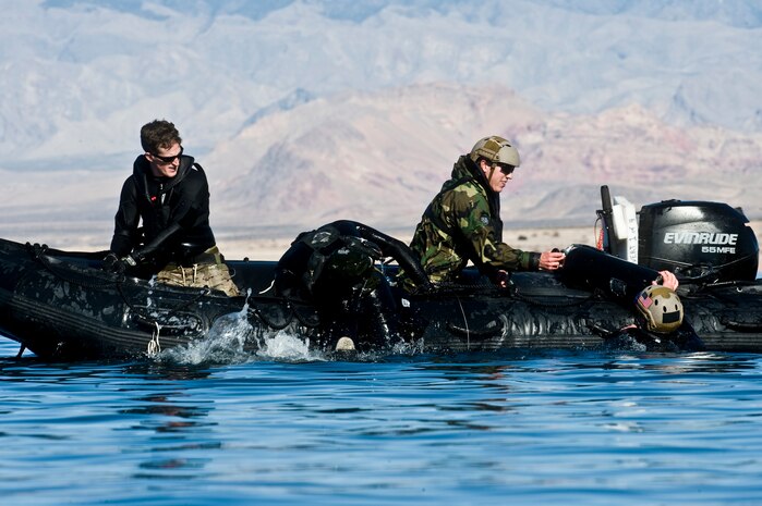 U.S. Air Force pararescuemen, 58th Rescue Squadron, get into a zodiac boat  during a military freefall water jump Jan. 10, 2012, at Echo Bay, Nev. Pararescuemen are trained to provide emergency medical treatment in adverse terrain and conditions in combat or peacetime. (U.S. Air Force photo by Airman 1st Class Daniel Hughes/Released)
