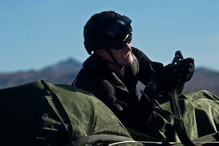 A U.S. Air Force pararescueman, 58th Rescue Squadron, takes straps off of a Rigging, Alternate Method Zodiac during a military freefall water jump Jan. 10, 2012, at Echo Bay, Nev. Pararescuemen are trained to provide emergency medical treatment in adverse terrain and conditions in combat or peacetime. (U.S. Air Force photo by Airman 1st Class Daniel Hughes/Released)
