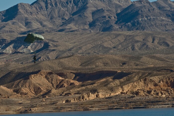 A U.S. Air Force pararescueman, 58th Rescue Squadron, prepares for a water landing during a military freefall water jump Jan. 10, 2012, at Echo Bay, Nev. Pararescuemen are trained to provide emergency medical treatment in adverse terrain and conditions in combat or peacetime. (U.S. Air Force photo by Airman 1st Class Daniel Hughes/Released)

