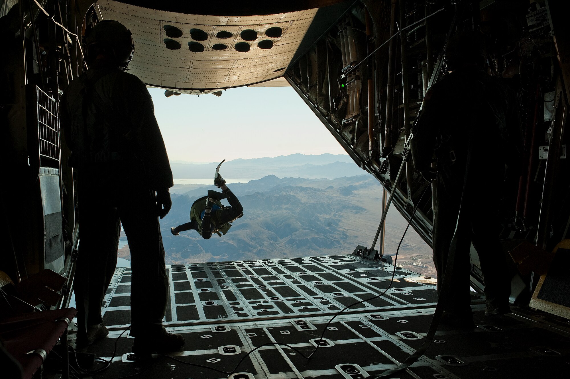 A U.S. Air Force pararescueman, 58th Rescue Squadron, jumps out of a C-130 Hercules, Air National Guard, Long Island, NY, during a military freefall water jump Jan. 10, 2012, over Echo Bay, Nev. Pararescuemen are trained to provide emergency medical treatment in adverse terrain and conditions in combat or peacetime. (U.S. Air Force photo by Staff Sgt. Christopher Hubenthal/Released)
