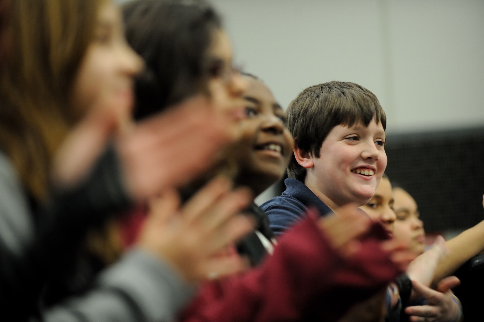 A middle school student claps during a performance by the U.S. Air Force Band Ceremonial Brass Quintet during a clinic at the Osceola County School for the Arts in Kissimmee, Fla., Jan. 18, 2012. The U.S. Air Force Band conducts the education outreach programs to teach middle and high school students about the importance of life skills such as discipline, teamwork and perseverence. U.S. Air Force photo by Master Sgt. Adam M. Stump/RELEASED.