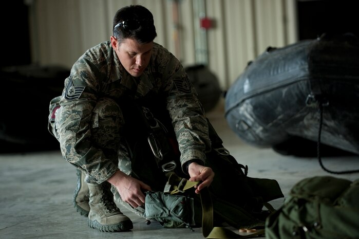 A U.S. Air Force pararescueman, 58th Rescue Squadron, prepares and checks equipment prior to a military freefall water jump Jan. 9, 2012, at Nellis Air Force Base, Nev. Pararescuemen are trained to provide emergency medical treatment in adverse terrain and conditions in combat or peacetime. (U.S. Air Force photo by Staff Sgt. Christopher Hubenthal/Released)
