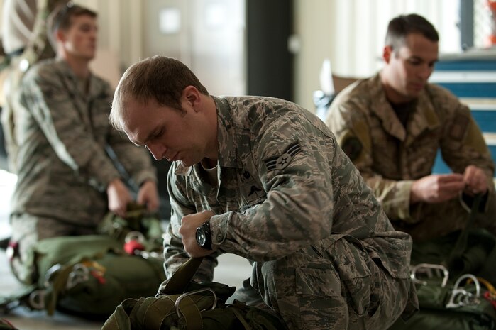 A U.S. Air Force pararescueman, 58th Rescue Squadron, prepares and checks equipment prior to a military freefall water jump Jan. 9, 2012, at Nellis Air Force Base, Nev. Pararescuemen are trained to provide emergency medical treatment in adverse terrain and conditions in combat or peacetime. (U.S. Air Force photo by Staff Sgt. Christopher Hubenthal/Released)
