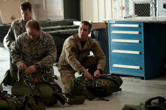 U.S. Air Force pararescuemen, 58th Rescue Squadron, prepare and check equipment prior to a military freefall water jump Jan. 9, 2012, at Nellis Air Force Base, Nev. Pararescuemen are trained to provide emergency medical treatment in adverse terrain and conditions in combat or peacetime. (U.S. Air Force photo by Staff Sgt. Christopher Hubenthal/Released)
