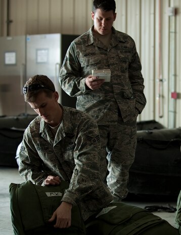 U.S. Air Force pararescuemen, 58th Rescue Squadron, adjust and inspect  equipment prior to a military freefall water jump Jan. 9, 2012, at Nellis Air Force Base, Nev. Pararescuemen are trained to provide emergency medical treatment in adverse terrain and conditions in combat or peacetime. (U.S. Air Force photo by Staff Sgt. Christopher Hubenthal/Released)
