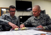 MINOT AIR FORCE BASE, N.D. -- Master Sgt. Paul Huston, 5th Logistics Readiness Squadron fuels information service center section chief and Staff Sgt. Joshua Pierce, 5th LRS fuel support supervisor, review the fuels custodian binder here Jan. 17. The binder tracks who is authorized to utilize the various fuel tanks on base and who holds releasing authority on said tanks. Huston was a recent recipient of the Master Sergeant Gillespie Fuels Senior NCO award, a command level recognition. (U.S. Air Force photo/Airman 1st Class Stephanie Ashley)