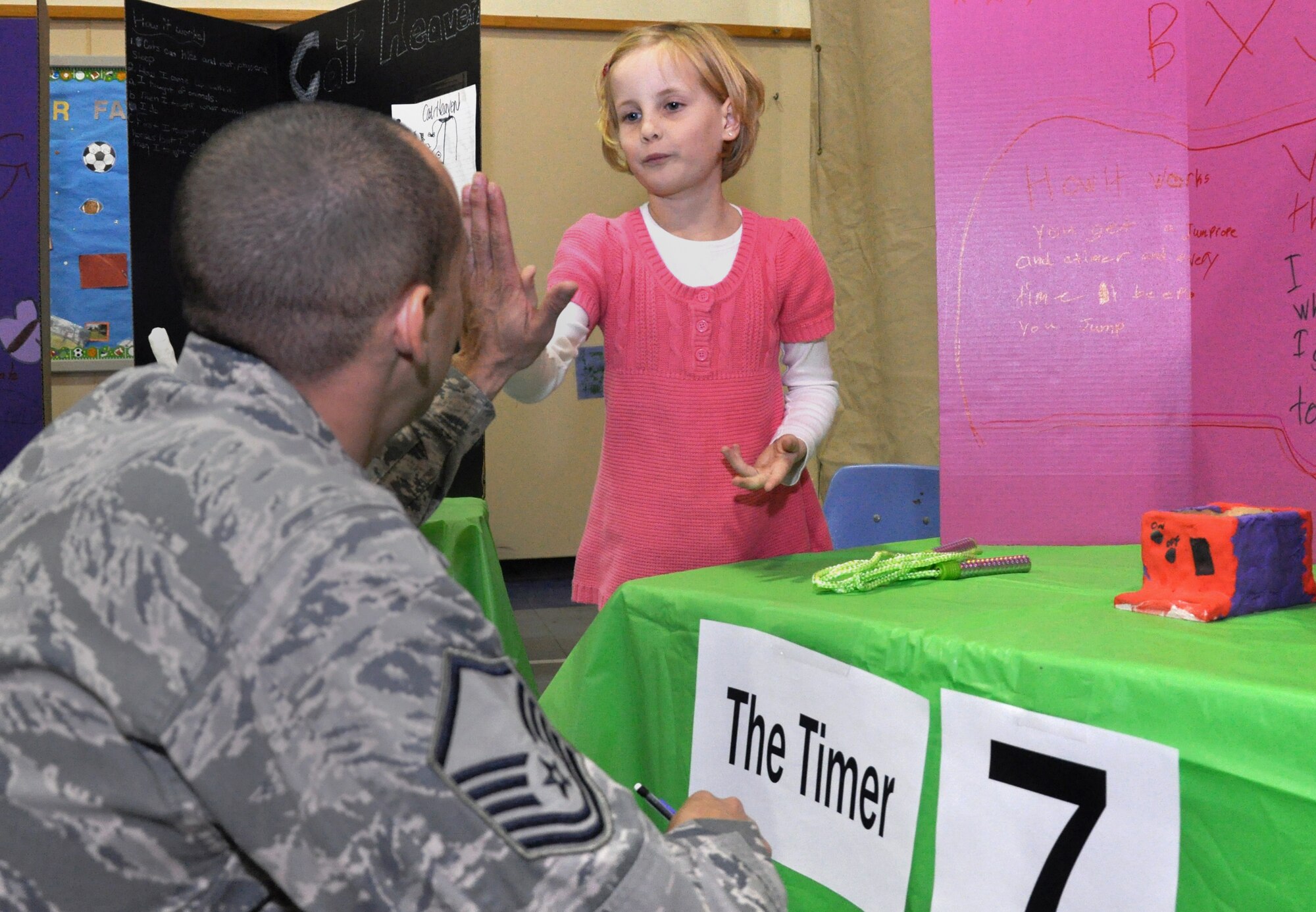 Sarah Schubert, left, the school age coordinator with the Youth Center, Marriannah Perez, center, daughter of 2nd Lt. Michelle Perez, 71st Medical Group, and Lyndsy Lewis, daughter of Master. Sgt. Erik Lewis, 71st Force Support Squadron, share a laugh during Invention Convention competition Jan. 17, at the Youth Center at Vance Air Force Base, Okla. Marriannah and Lyndsy won the Best Design award for their butterfly alarm clock. (U.S. Air Force photo/ Airman 1st Class Frank John Casciotta)