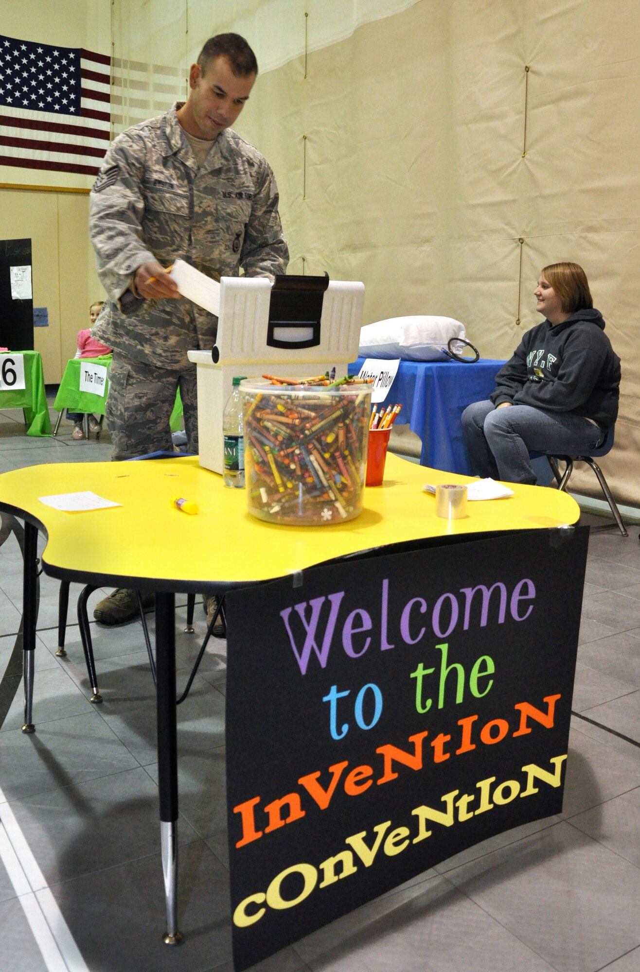 Tech. Sgt. Gary Eyster, with the 71st Security Forces Squadron, casts his vote in the Invention Convention competition Jan. 17 in the Youth Center at Vance Air Force Base, Okla.  Konner Wright, son of Lt. Col. Todd Wright, 32nd Flying Training Squadron, won the Bright Minds Big Ideas award for his Amazing Robot. The Best Idea award went to Conner Hayes, son of Lt. Col. Douglas Hayes, 71st Communication Squadron. Best Design went to Marriannah Perez, daughter of 2nd Lt. Michelle Perez, 71st Medical Group, and Lyndsy Lewis, daughter of Master. Sgt. Erik Lewis, 71st Force Support Squadron, for their butterfly alarm clock. Best Presentation award went to Sidney McAlear, daughter of Maj. Chris McAlear, 25th Flying Training Squadron. (U.S. Air Force photo/ Airman 1st Class Frank John Casciotta)