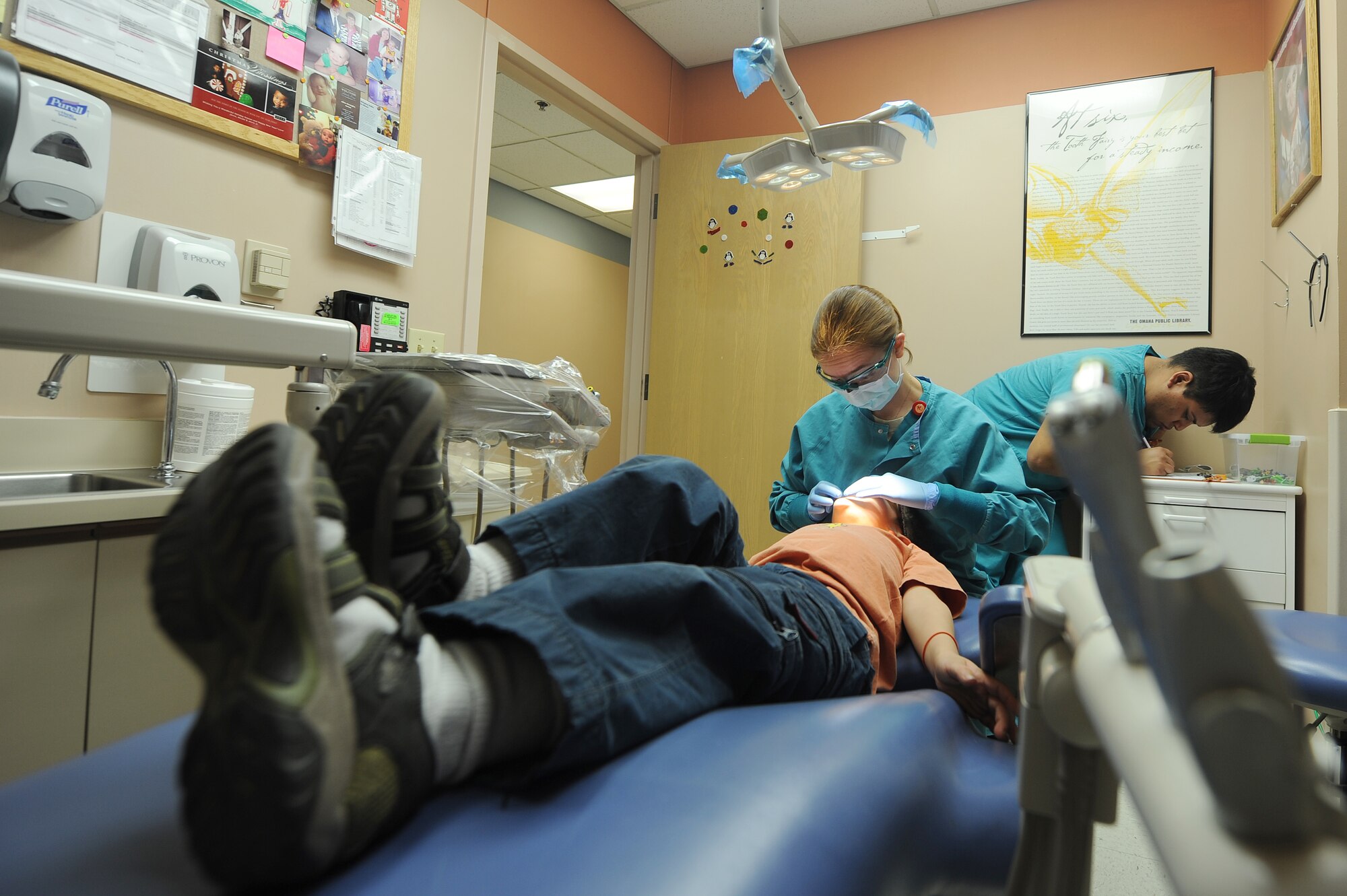 U.S. Air Force Maj. Amy Dyer, 99th Dental Squadron pediatric dentist, conducts a dental exam on Wyatt Neece, son of Anthony Neece, retired Master Sgt., as Javier Alcala, 99th Dental Squadron dental technician records medical data Jan. 17, 2012, at Nellis Air Force Base, Nev.  February is Children's Dental Health Month.  During the month, Airmen from the 99th Dental Squadron plan to educate military dependents on proper oral hygiene. They also will volunteer with Las Vegas valley dentists to assist with cleaning, general dentistry and special care for those in need. (U.S. Air Force photo by Staff Sgt. Christopher Hubenthal/Released)