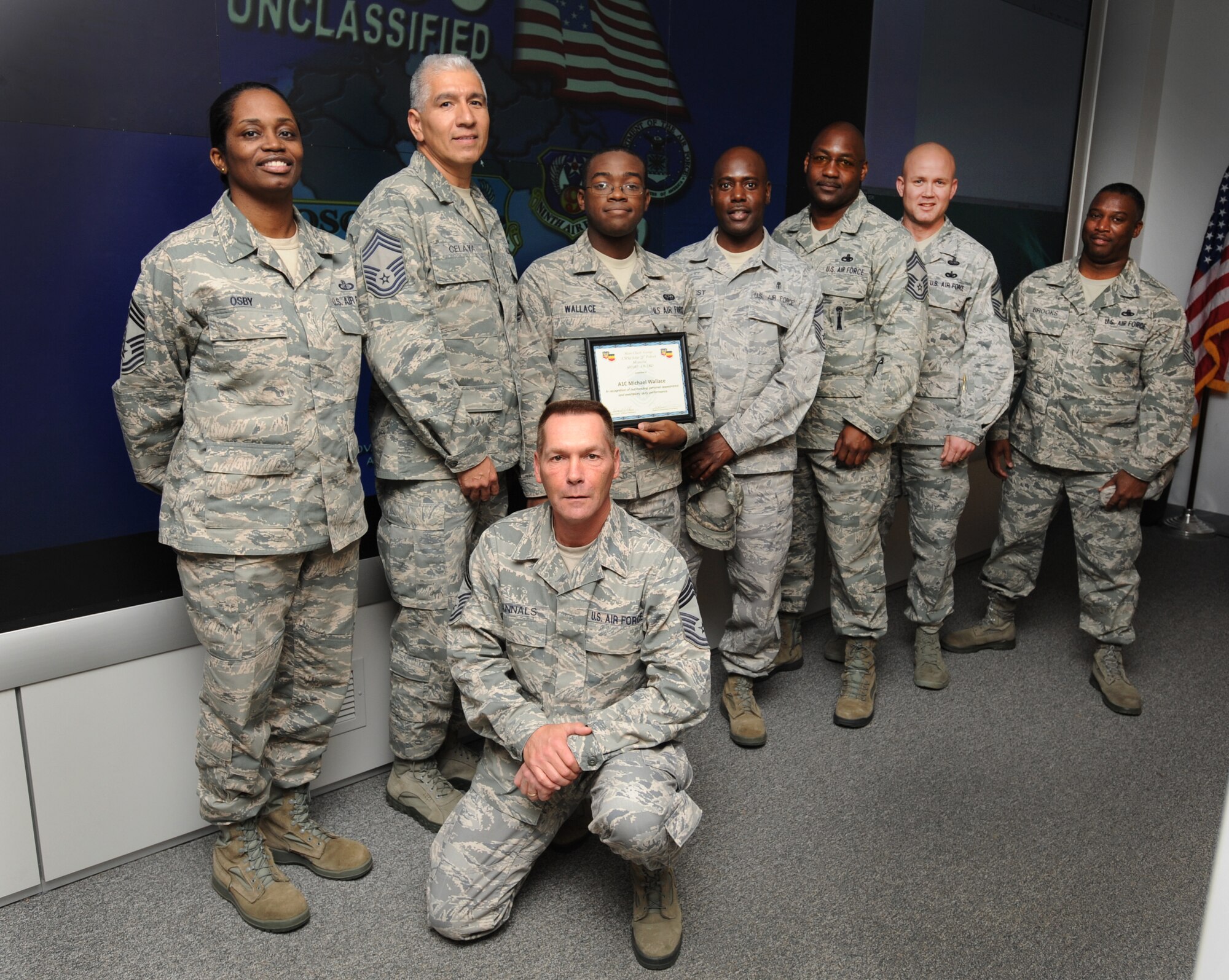 U.S. Air Force Airman 1st Class Michael Wallace, U.S. Air Forces Central enterprise controller, receives the Chief Master Sgt. J.J. Pollock award from the Chief's Group at Shaw Air Force Base, S.C., Jan. 18, 2012. Wallace is the Warrior of the Week for the week of Jan. 16 through 20. (U.S. Air Force photo by Airman 1st Class Tabatha McCarthy/Released)