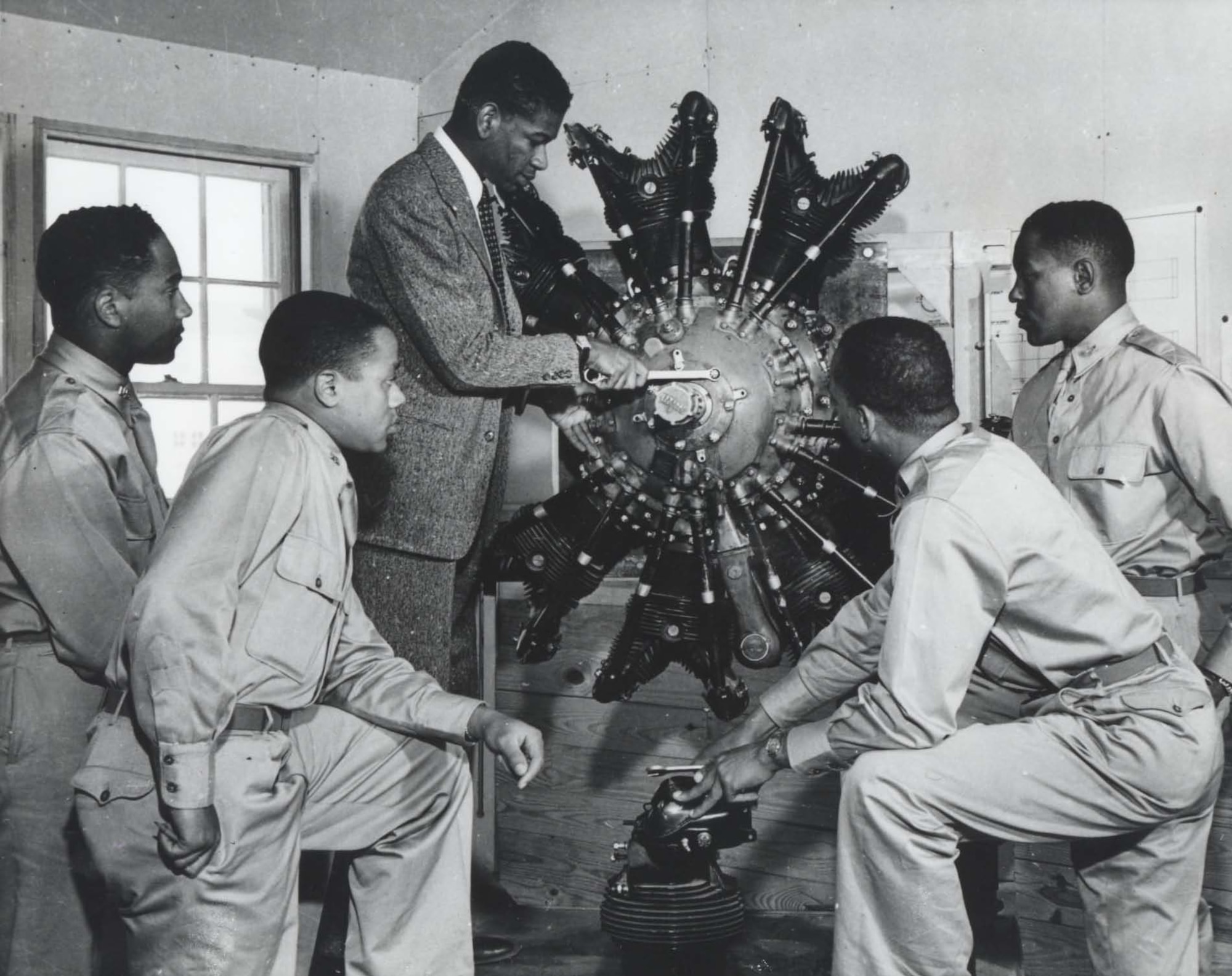 Cadets in ground school study a radial aircraft engine, 1942.