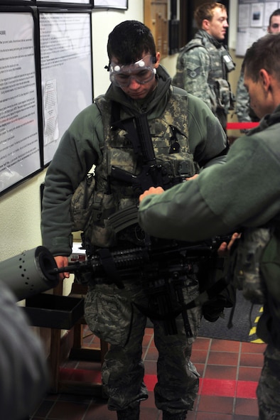 MINOT AIR FORCE BASE, N.D. -- Tech. Sgt. Robert Leighton, 5th Security Forces Squadron team member, has his rifle inspected and cleared by fellow companion, Airman 1st Class Kacey Langley, 5th Security Forces Squadron team member,  at the Security Forces building here Jan. 11. Security Forces members frequently inspect their weapons and ammunition to ensure they are working properly. (U.S. Air Force photo/Airman 1st Class Kristoffer Kaubisch)