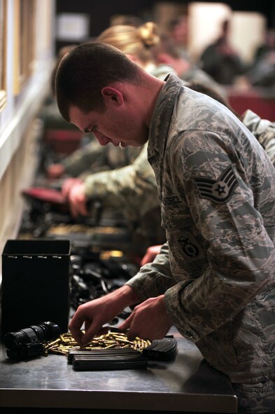 MINOT AIR FORCE BASE, N.D. -- Staff Sgt. Colin McLaughlin, 791st Missile Security Forces Squadron team member, counts rounds of ammunition at the Security Forces building here Jan. 11. Security Forces members frequently inspect their weapons and ammunition to ensure they are working properly. (U.S. Air Force photo/Airman 1st Class Kristoffer Kaubisch)