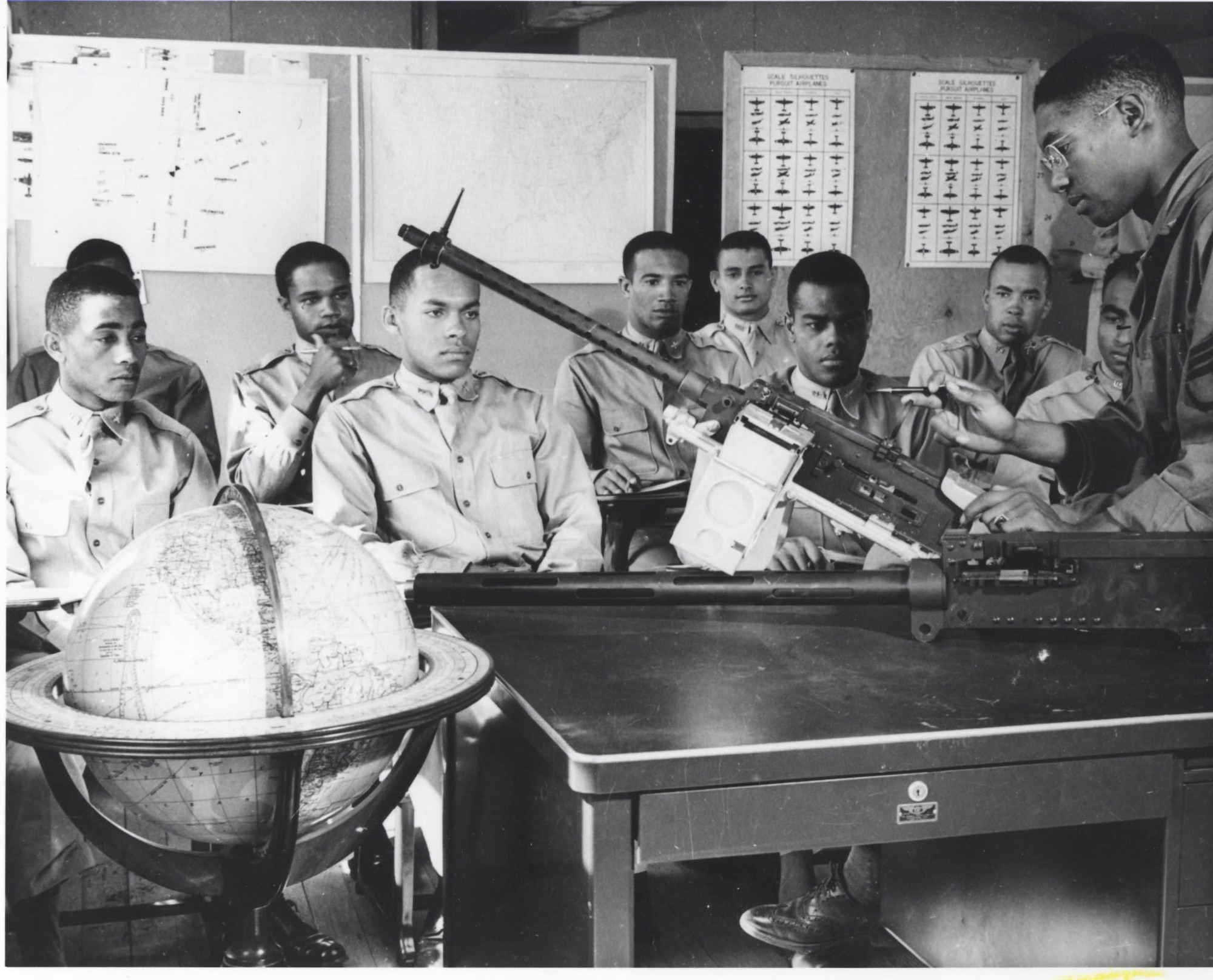 Cadets in armament class study 30 calibre machine gun, 1942.