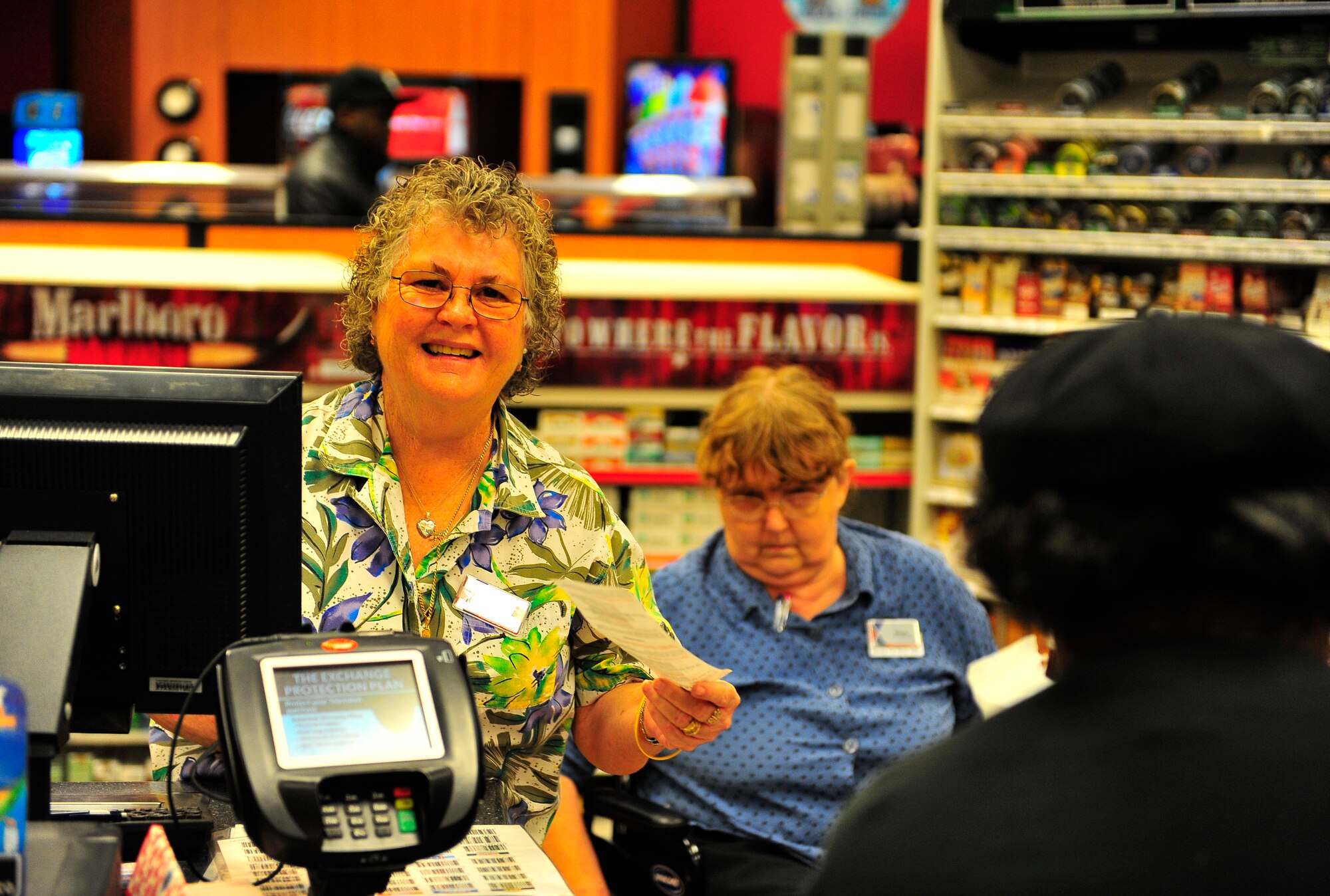 Patricia Langley helps a customer with purchasing her goods at the recently renovated shoppette at Shaw Air Force Base, S.C. Jan. 17, 2011. Approximately $400,000 of renovations were completed to accomodate the growing population of Shaw, resulting in faster service and a greater capacity for goods. Patricia has worked at the shoppette for 12 years. (U.S. Air Force photo/Senior Airman Neil D. Warner/Released)