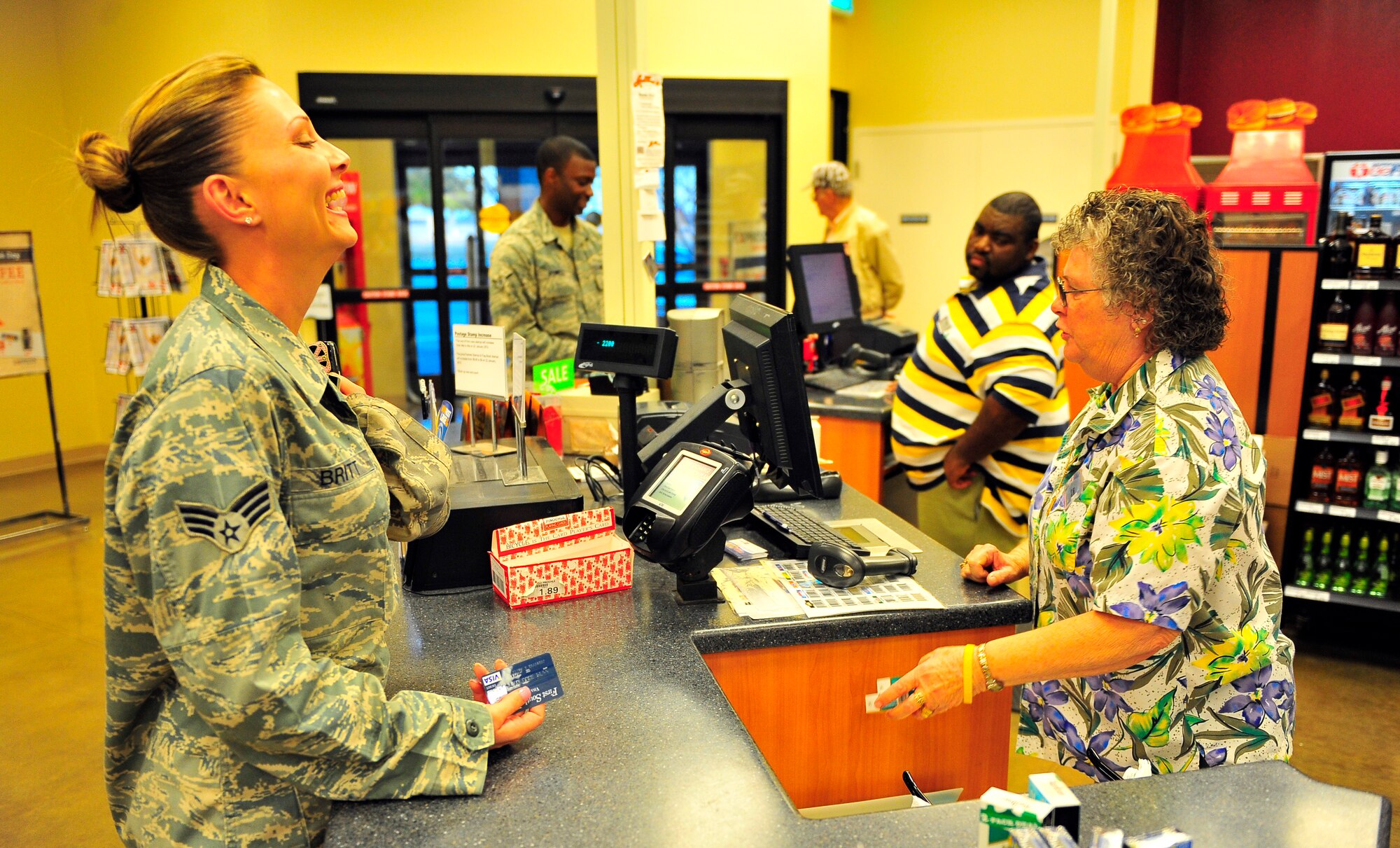 U.S. Air Force Senior Airman Jennifer Britt, 20th Communications Squadron account manager, laughs while having a conversation with Patricia Langley at the recently renovated shoppette at Shaw Air Force Base, S.C. Jan. 17, 2011. Approximately $400,000 of renovations were completed to accomodate the growing population of Shaw, resulting in faster service and a greater capacity for goods. Patricia has worked at the shoppette for 12 years.  (U.S. Air Force photo/Senior Airman Neil D. Warner/Released)