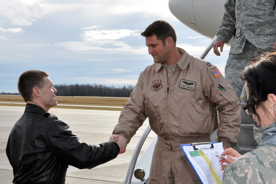 YOUNGSTOWN AIR RESERVE STATION, Ohio – Air Force Reserve Col. Craig Peters, 910th Operations Group commander, greets Capt. Chris Brown, a C-130H “Hercules” cargo aircraft pilot assigned to the 757th Airlift Squadron, as he steps off a stair truck from a chartered commercial airliner on the flightline here, Jan. 17, 2012. Brown is one of approximately 100 Citizen Airmen, assigned to the 910th Airlift Wing’s flying and maintenance squadrons based here, are returning to Northeast Ohio after a 120-day deployment to Southwest Asia. While deployed, the 910th Air Force Reservists provided support to airlift operations to various military installations throughout the U.S. Central Command (USCENTCOM) Area of Operations (AOR). U.S. Air Force photo by Master Sgt. Bob Barko Jr.