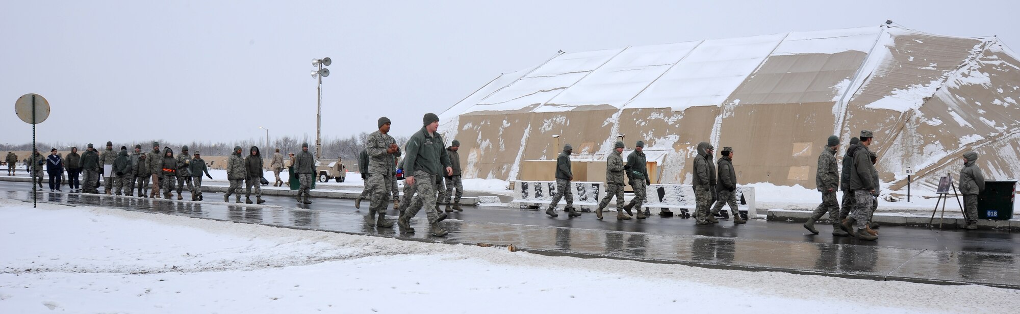 In deployed locations, Martin Luther King Jr. Day is another work day, but Airmen, Soldiers and contractors stationed and working at the Transit Center at Manas, Kyrgyzstan, took a few minutes out of their day to participate in a Martin Luther King Jr. commemorative walk Jan. 16, 2012. The walk began in the transient tent area and ended at the community activities center where the gospel choir shared music with the crowd and guest speaker Maj. Virgil Scott, the deputy commander for the 376th Expeditionary Medical Group, reflected on Dr. King's life and legacy.
(U.S. Air Force photo/Master Sgt. Tracy L. DeMarco)
