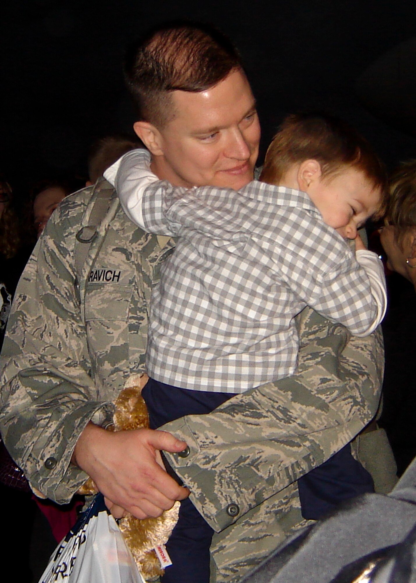 Capt. Frank Azaravich hugs his son after returning home Jan. 17. Friends and family welcomed home more than 200 members of the 728th Air Control Squadron.  The Airmen, who arrived from Southwest Asia,  provide command and control of joint air operations by conducting surveillance, identification, weapons control, battle management and theater communications data link.  (U.S. Air Force photo/Lois Walsh)