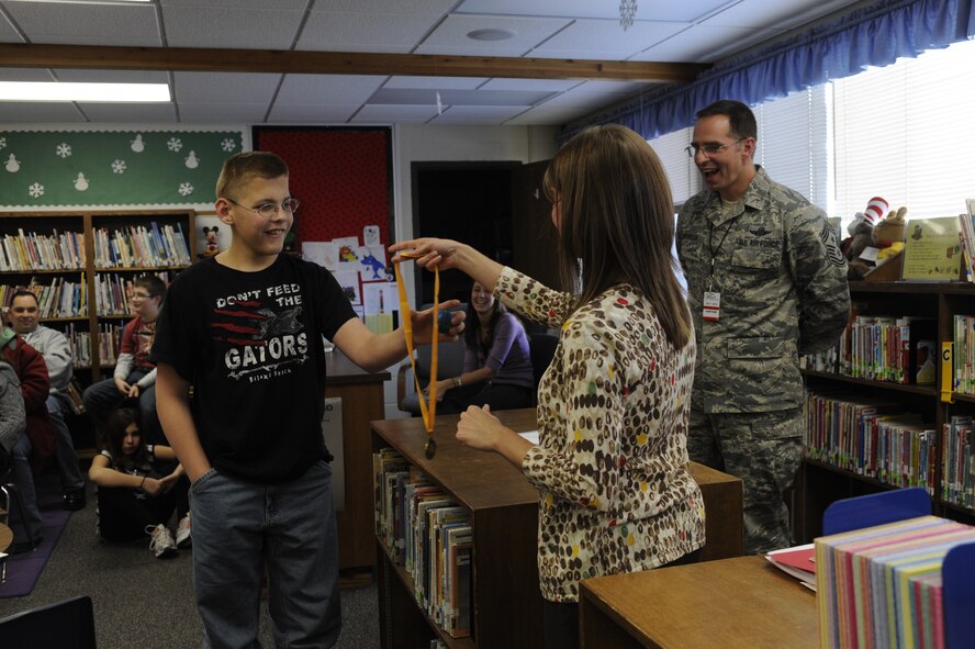 MINOT AIR FORCE BASE, N.D. – Cody Clark, Dakota Elementary 6th grade student and son of Tech. Sgt Kevin Clark, 5th Operations Support Squadron aircrew flight equipment technician, receives a medal for winning the 2012 Dakota Elementary Geography Bee Jan. 12. Cody will have the opportunity to go on to the state championships following a written qualifying exam. (U.S. Air Force photo/Airman 1st Class Stephanie Ashley)