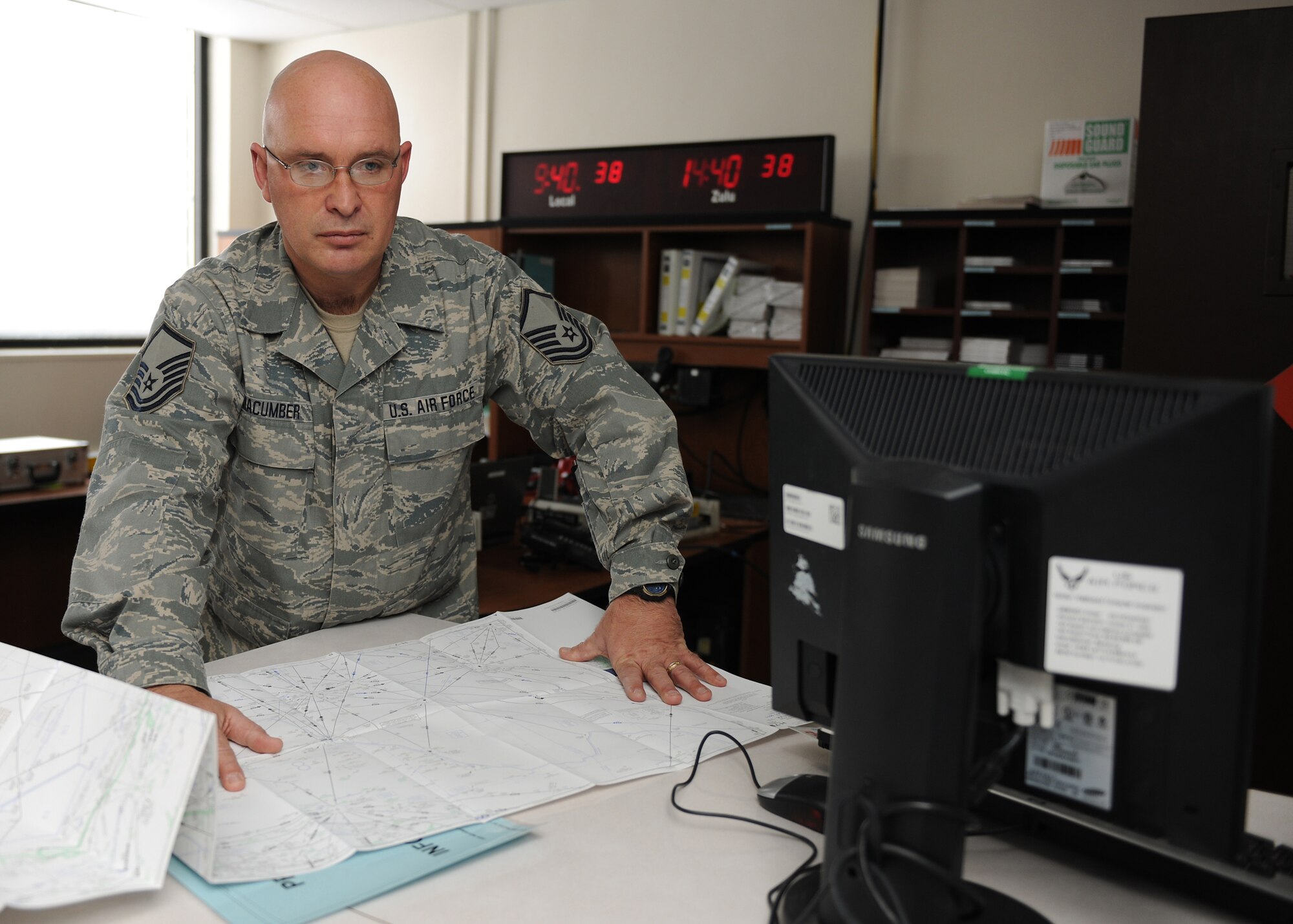 New York Air National Guard Master Sgt. Richard Macumber trains with maps in the airfield operations office located at Hancock Field Air National Guard Base in Syracuse NY, on 3 January 2012. Master Sgt Macumber was selected to represent Hancock Field at the state level in the outstanding Airman of the Year competition in the Senior NCO category. (photo by Tech. Sgt. Ricky Best/RELEASED)