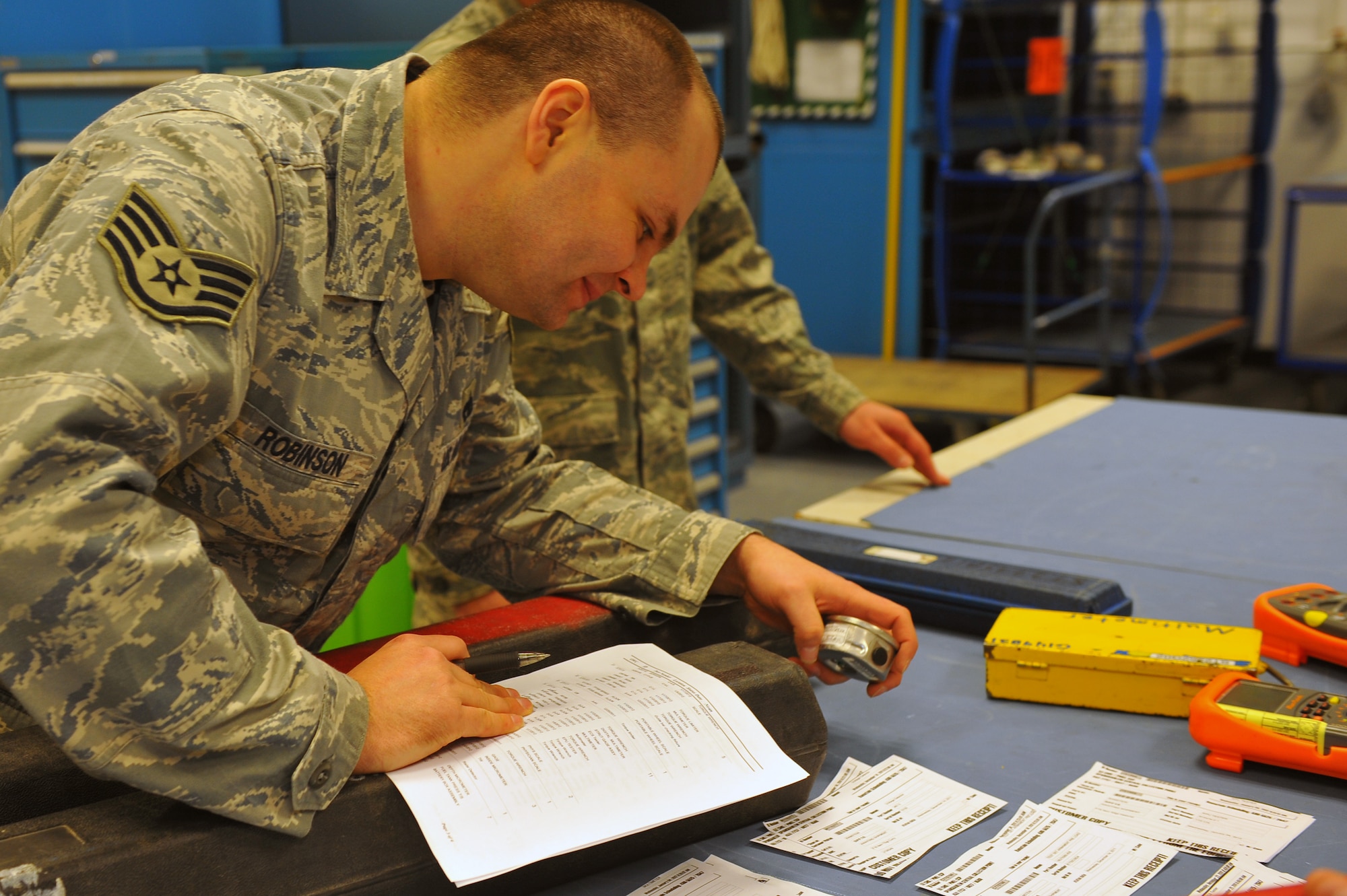 SPANGDAHLEM AIR BASE, Germany – Staff Sgt. Joseph Robinson, 52nd Component Maintenance Squadron electronic warfare craftsman, ensures all calibrated equipment is accounted for inside the precision measurement equipment laboratory centralized collection point (PMEL CCP) here Jan. 18 before it can be picked up by the owner’s unit. PMEL CCP saves the Air Force money by gathering equipment from 77 separate unit accounts and delivering them to the precision measurement equipment laboratory at Ramstein Air Base in one truckload rather than 77 separate trips. The PMEL CCP delivers unit equipment ranging from a torque wrench to radio frequency signal generators used to calibrate aircraft avionics systems. (U.S. Air Force photo/Airman 1st Class Dillon Davis)
