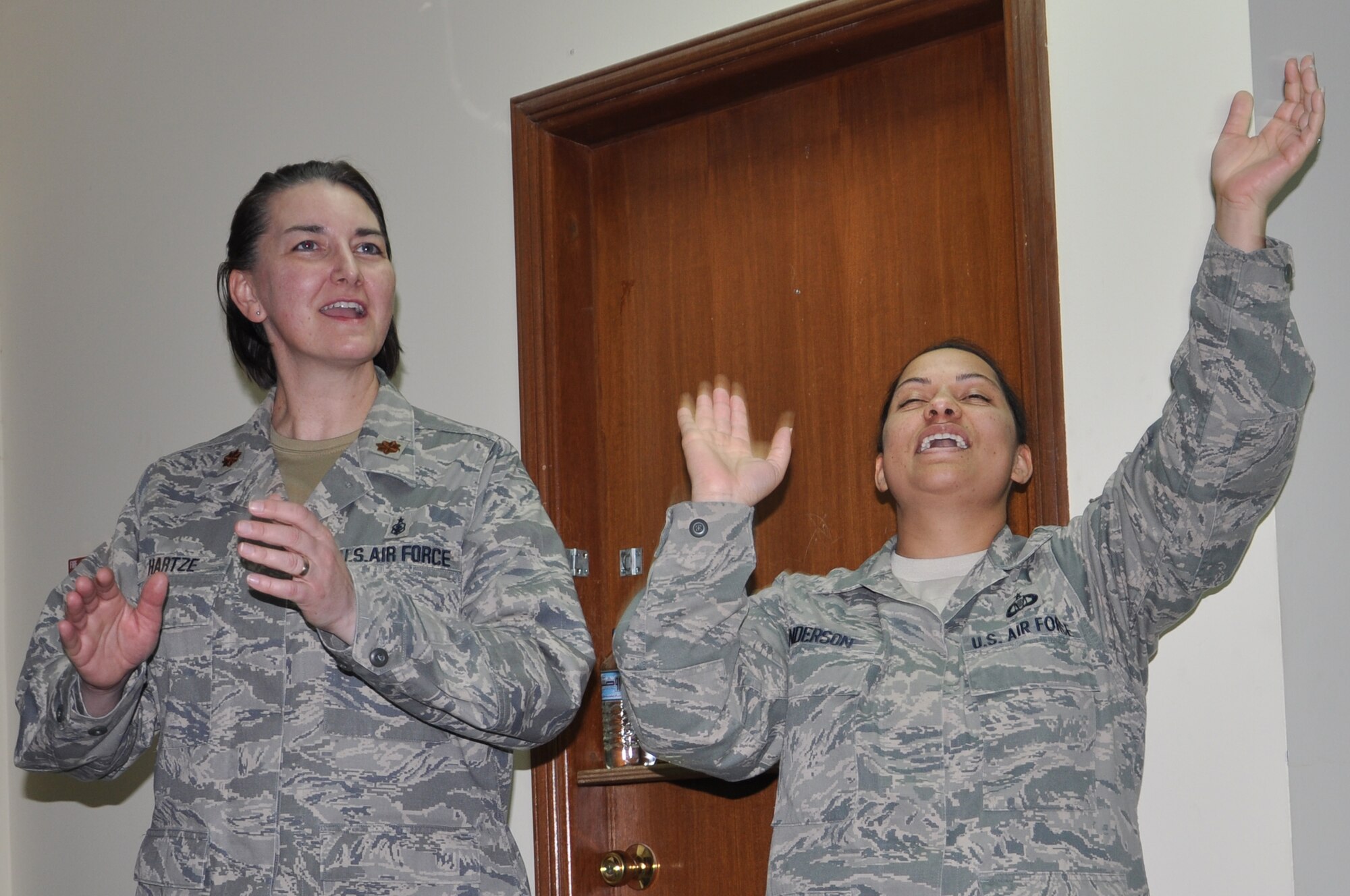 Maj. Rachelle Hartze, 332nd Expeditionary Medical Squadron and Tech. Sgt. Jennifer Anderson, 332nd Air Expeditionary Wing, sing during a Martin Luther King Jr. Day celebration in the base chapel at an undisclosed location in Southwest Asia Jan. 16, 2012. Hartze is deployed from Ellsworth Air Force Base, S.D. and Anderson from Seymour Johnson Air Force Base, N.C. (photo by Senior Airman Melanie Holochwost)