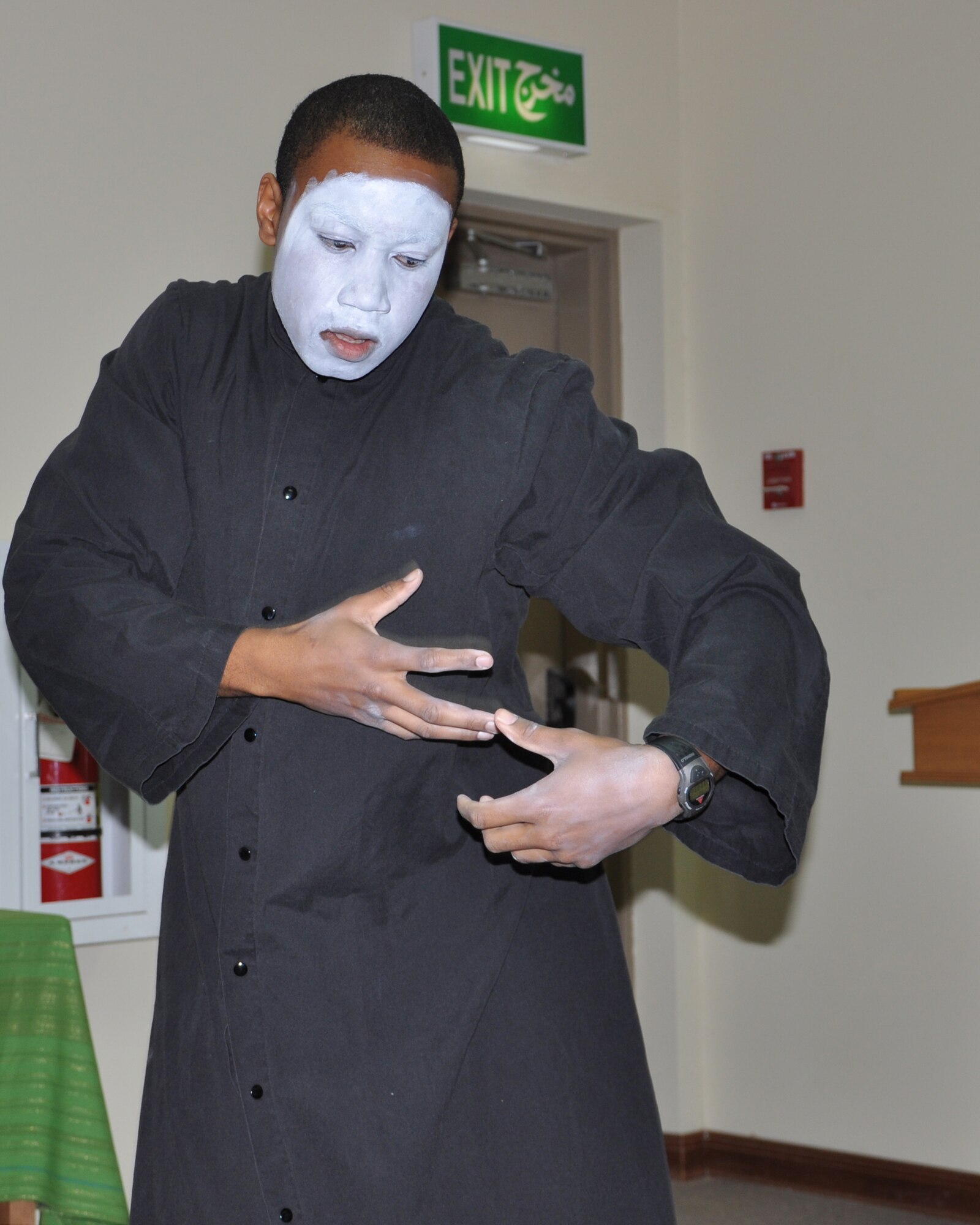 Airman 1st Class Troy Tucker, 332nd Expeditionary Logistic Readiness Squadron, mimes a song Jan. 16, 2012 during a Martin Luther King Jr. Day celebration at an undisclosed location in Southwest Asia. Tucker is also the lead vocalist and performed several solos. He is deployed from Shaw Air Force Base, S.C. (photo by Senior Airman Melanie Holochwost)